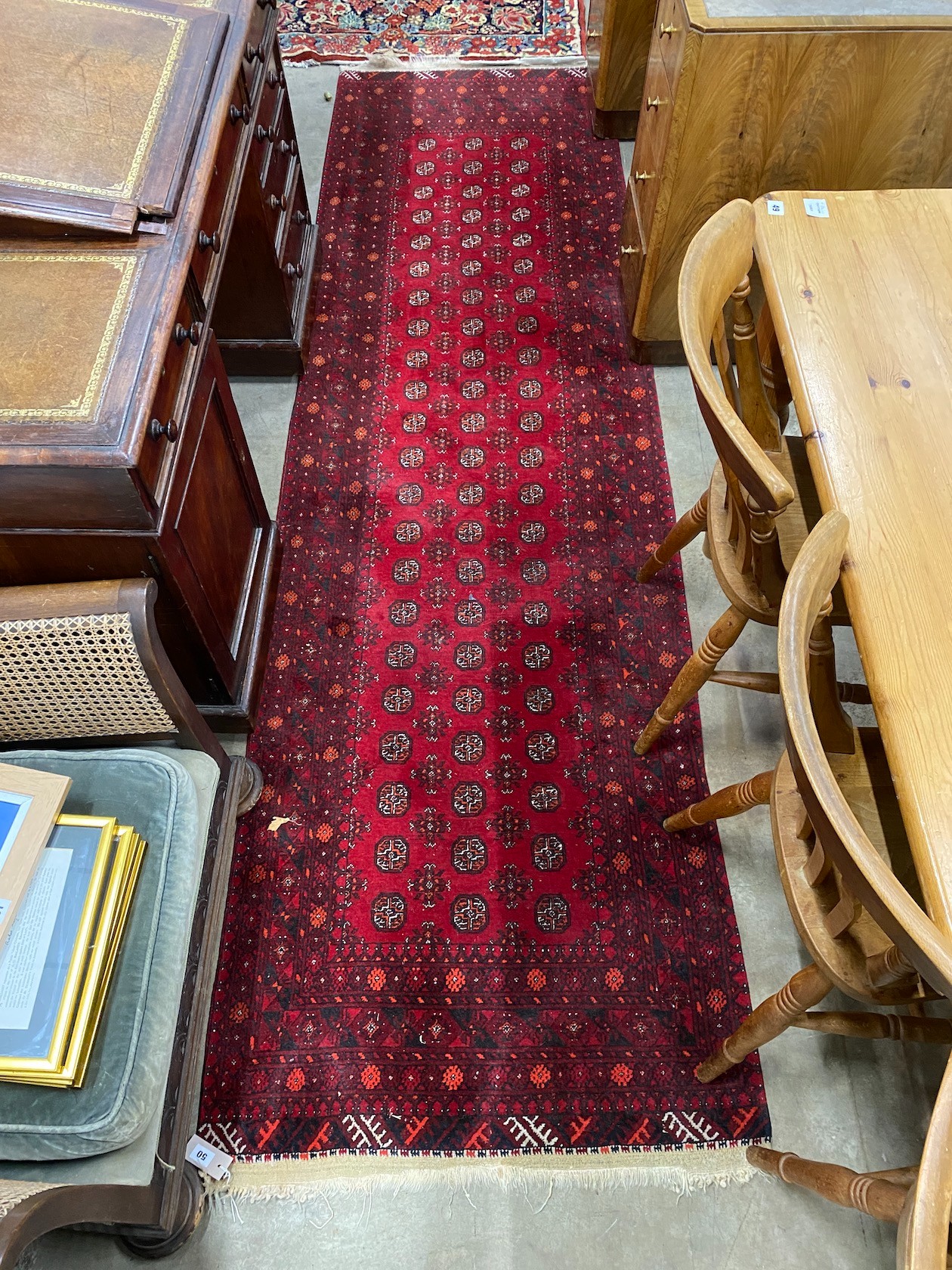 A Bokhara red ground runner 290cms x 85cms